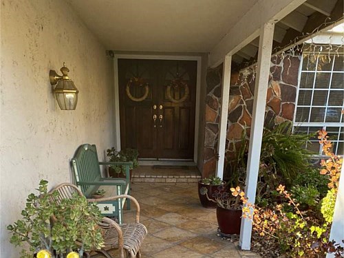 Entrance The color of the existing rock facade is unattractive in this residence. The tile used in this entrance accentuates the best colors of the rock facade.