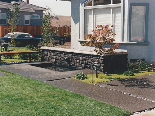 Entrance Providing a fountain in this spacious yard provides “white noise” beside a busy residential street. Guests can linger beside the fountain on their exit by sitting on the bench.