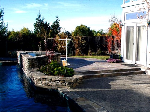 Pool Spa Having amenities close to the residence assures maximum use. This spa is close to the Master Bedroom. To make the spa and residence close the same elevation is provided. An additional benefit of a waterfall is now available, from the spa to the pool.