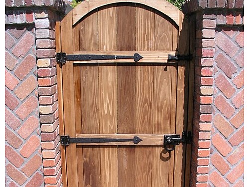 Backyard Gate This gate is designed with an attractive iron hardware painted black.